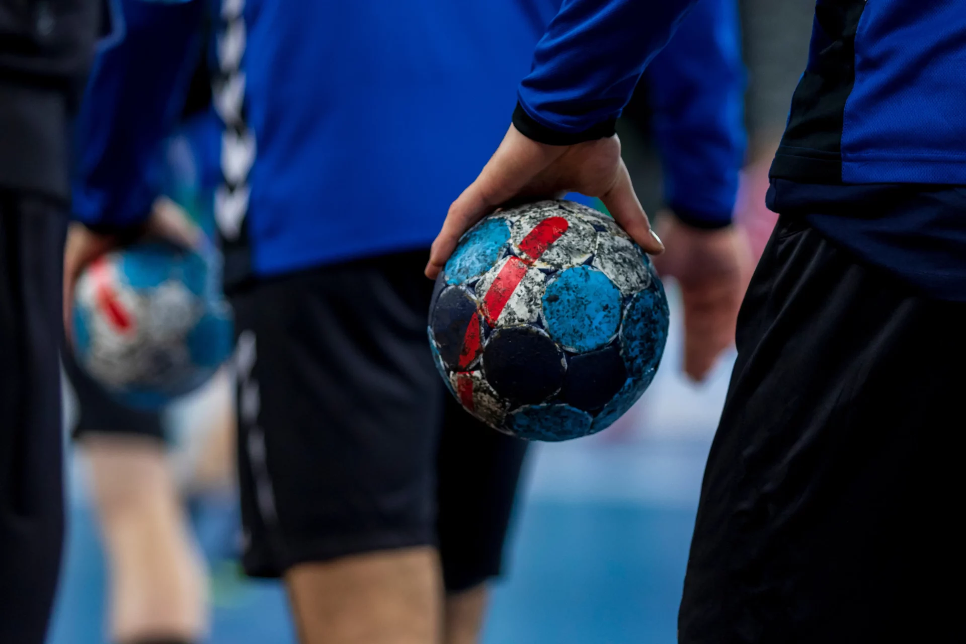 Gros plan sur un joueur tenant un ballon de handball avant un match.