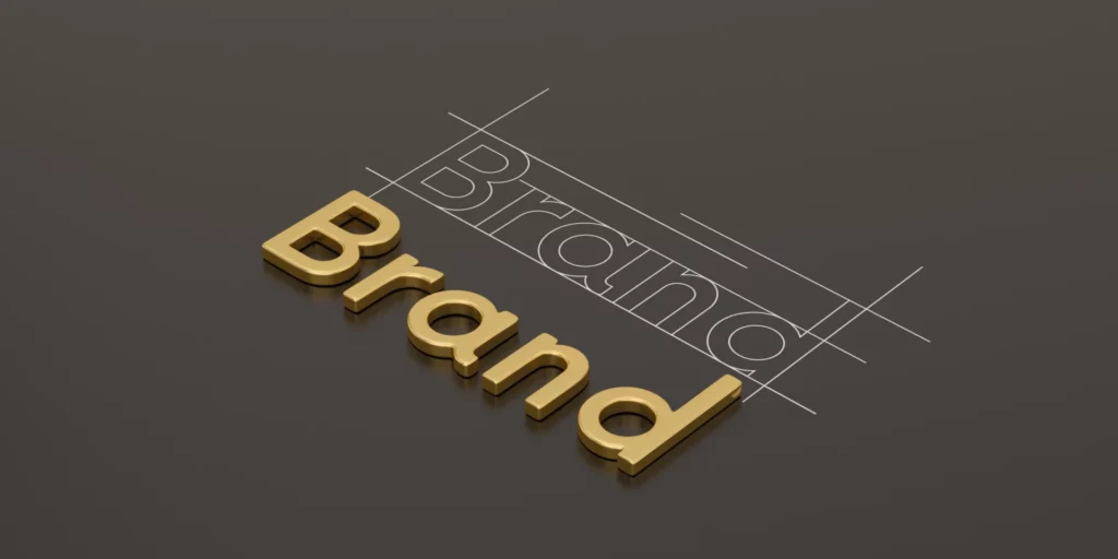 Illustration du mot "Brand" en lettres dorées, représentant le concept d'identité de marque.